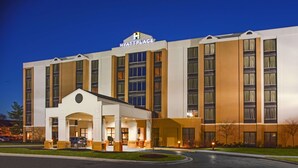 A multi-story hotel with a prominent 'Hyatt Place' sign, a central entrance with columns, and a well-lit facade. - Hyatt Place Cincinnati/Blue Ash (Cincinnati)
