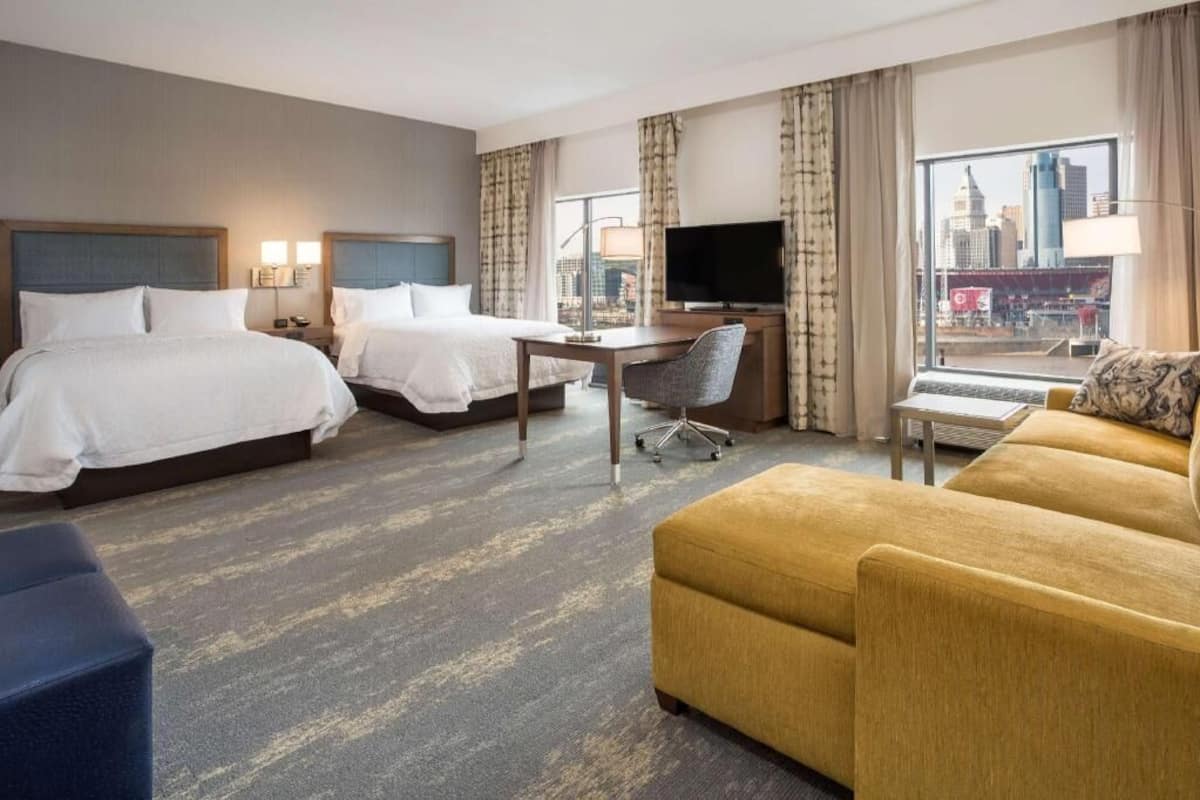 Premium bedding, desk, laptop workspace, blackout drapes