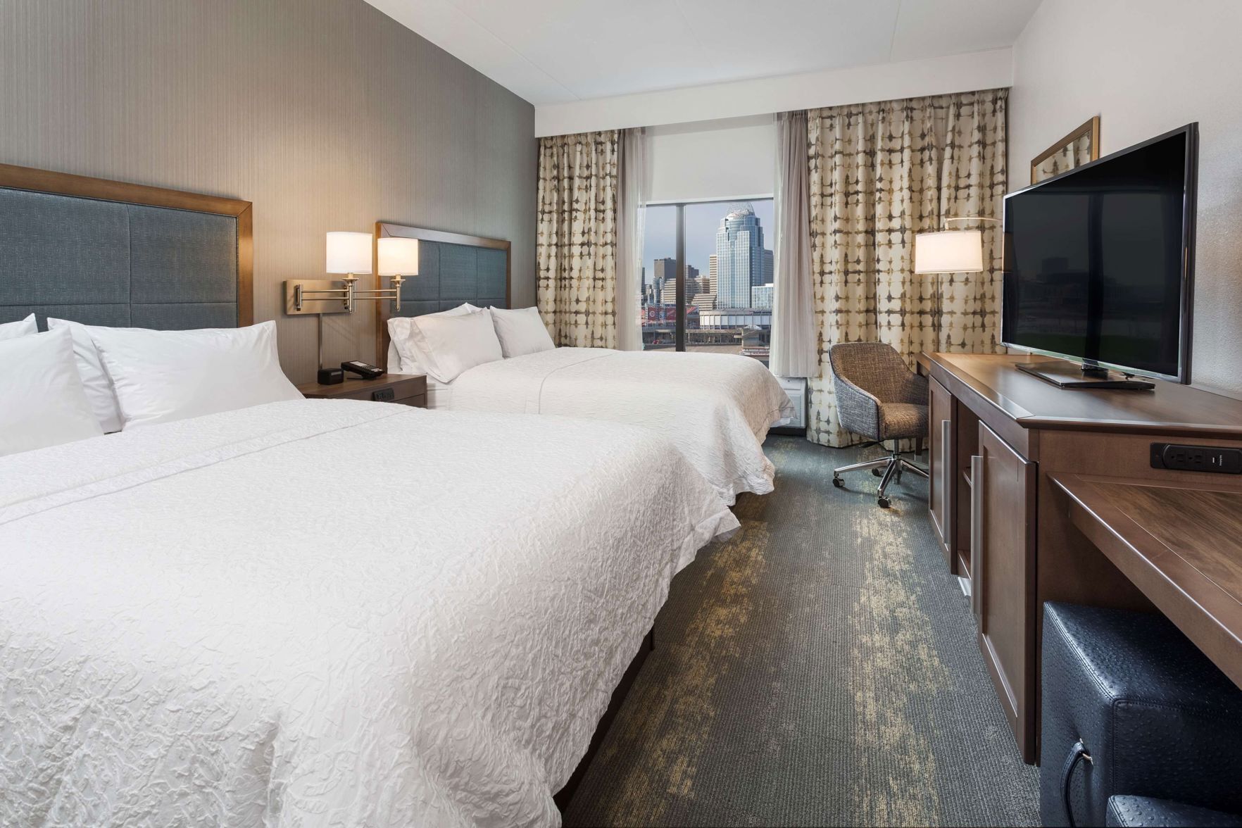 Premium bedding, desk, laptop workspace, blackout drapes