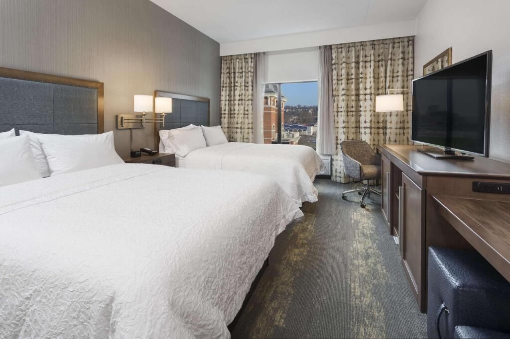 Premium bedding, desk, laptop workspace, blackout drapes