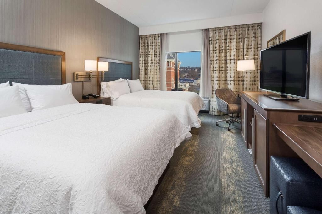 Premium bedding, desk, laptop workspace, blackout drapes
