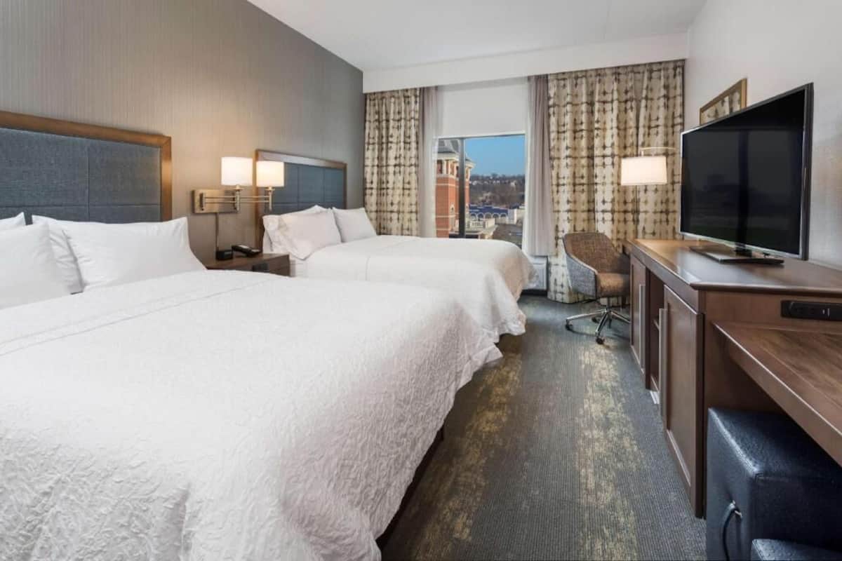 Premium bedding, desk, laptop workspace, blackout drapes