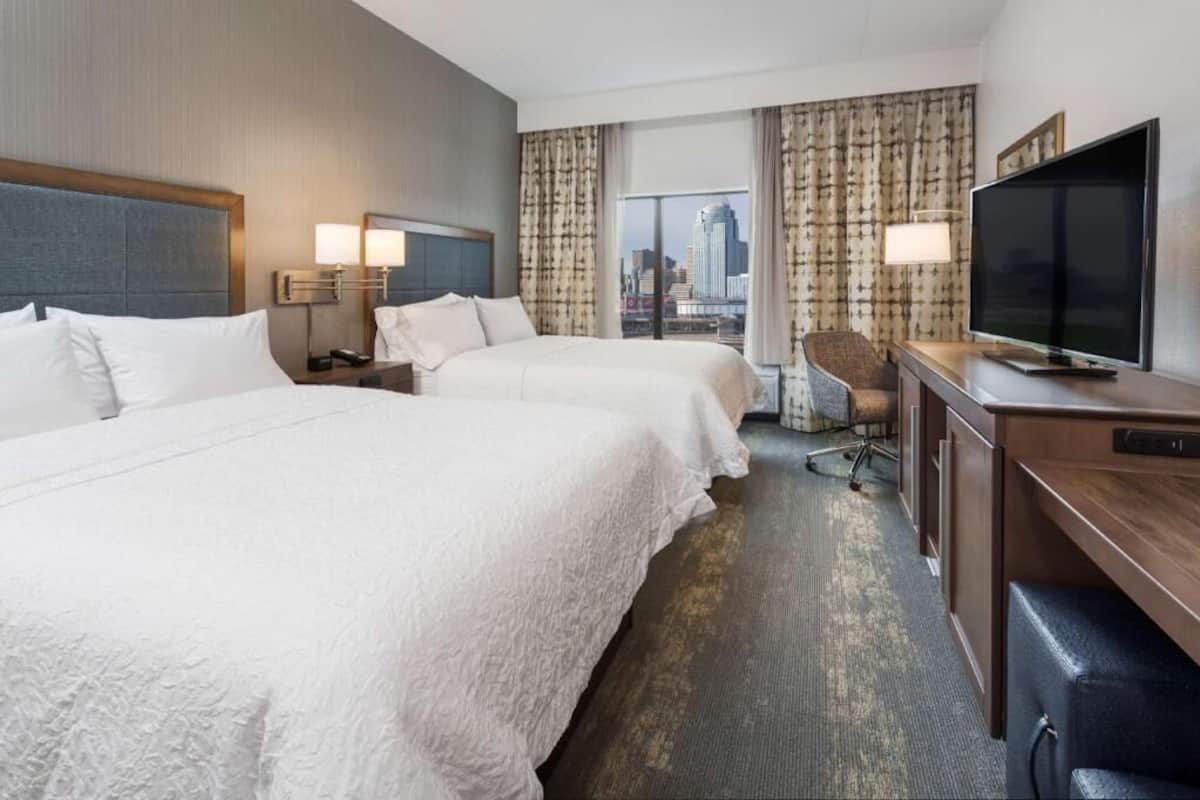 Premium bedding, desk, laptop workspace, blackout drapes