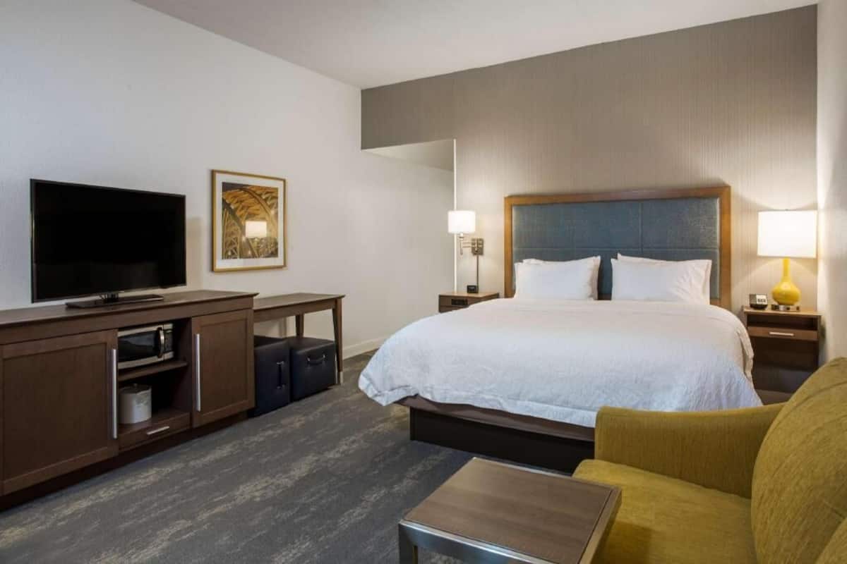 Premium bedding, desk, laptop workspace, blackout drapes