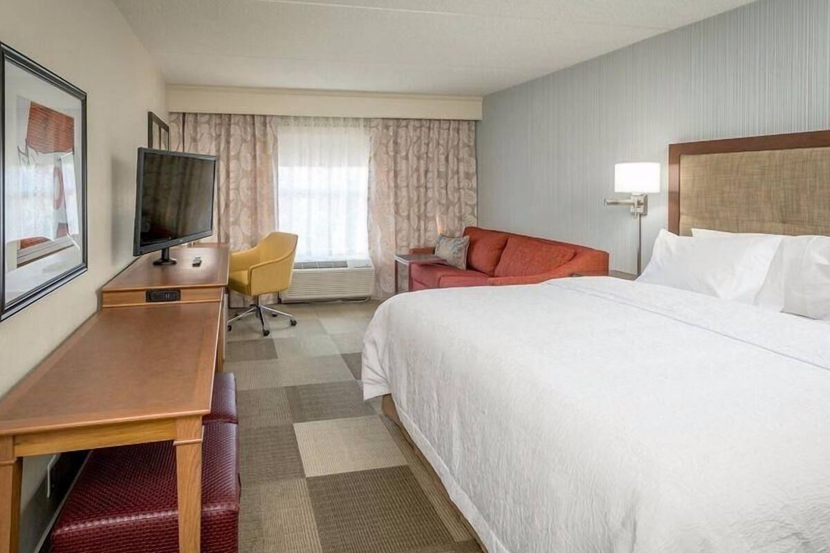 Premium bedding, desk, laptop workspace, blackout drapes