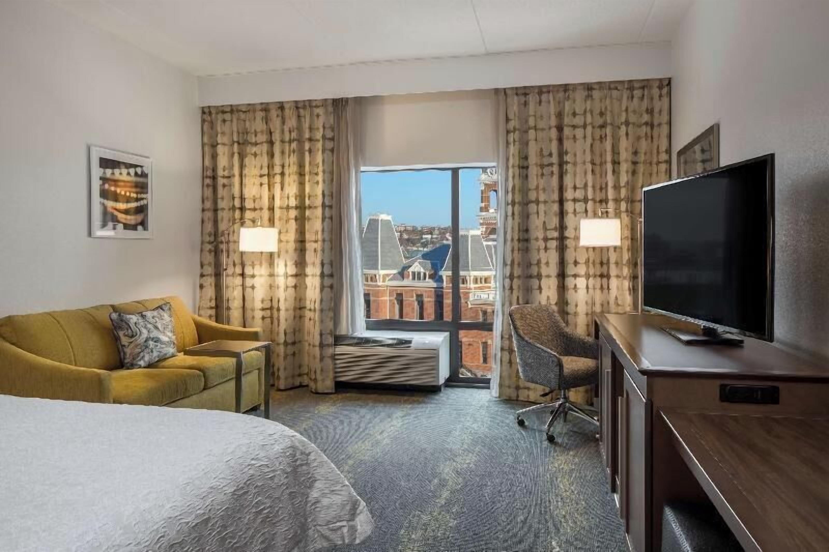 Premium bedding, desk, laptop workspace, blackout drapes