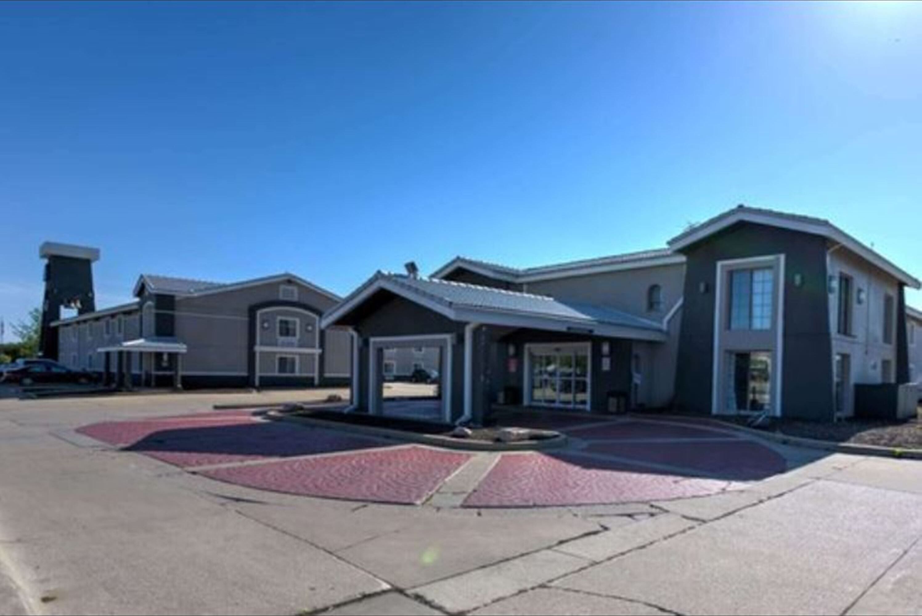 A modern building with multiple entry points, including a covered driveway and a main entrance.