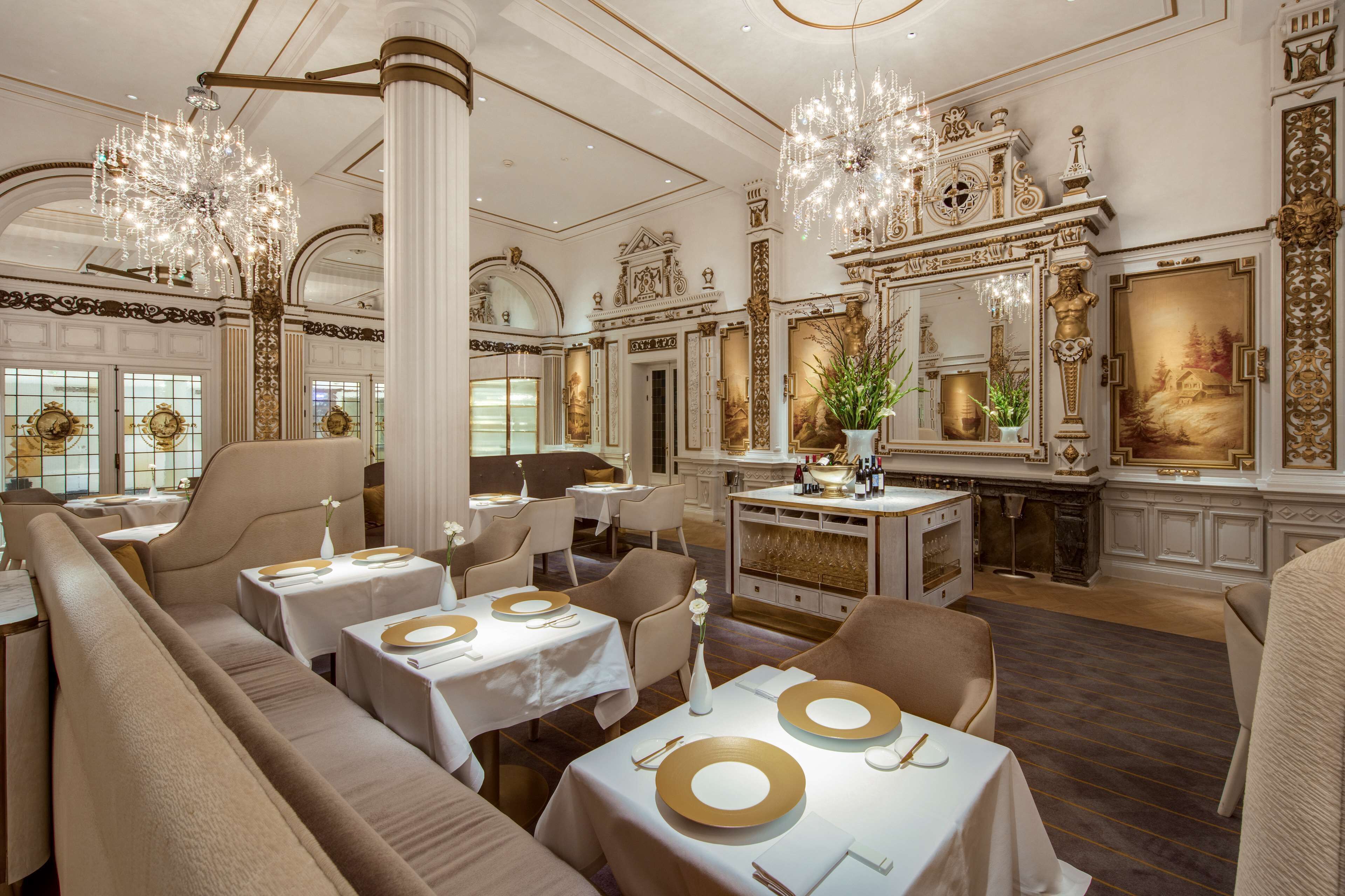 A luxurious dining area with elegant chandeliers, ornate decor, and a classic interior design.