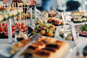 A buffet with various dishes, including appetizers and salads.