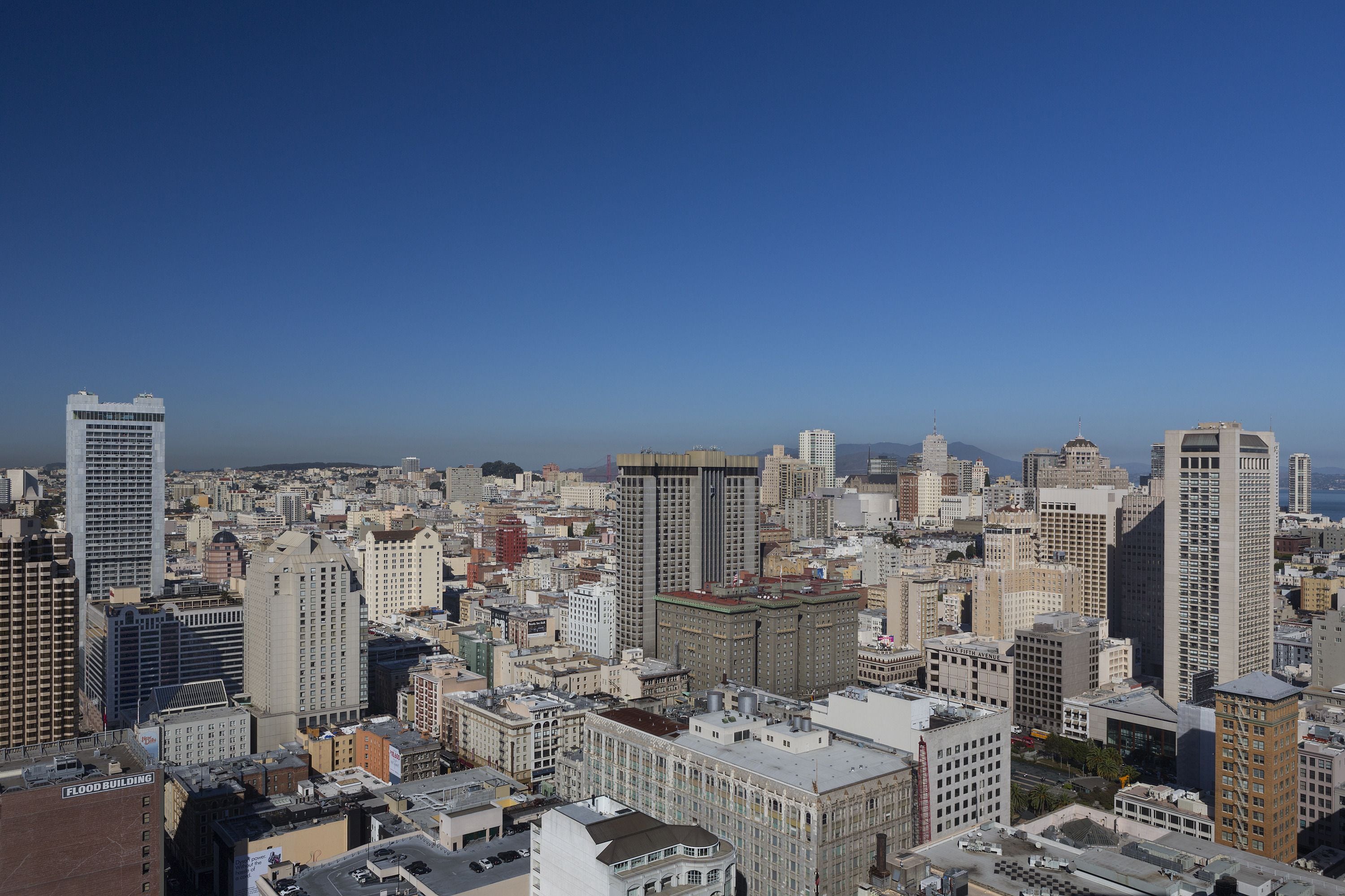 A cityscape with various buildings, including high-rise structures and mid-rise buildings.