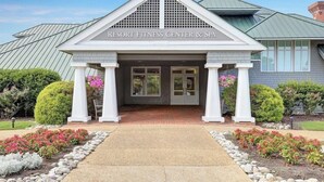 A building labeled "Resort Fitness Center & Spa" with a symmetrical facade, white columns, and a central entrance.