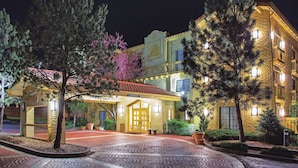 A hotel with a traditional facade, a covered entrance, and a well-lit exterior. - La Quinta Inn by Wyndham Denver Westminster (Westminster)