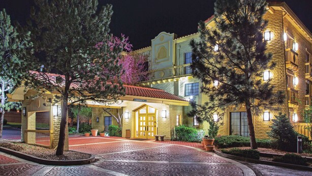 A hotel with a traditional facade, a covered entrance, and a well-lit exterior. - La Quinta Inn by Wyndham Denver Westminster (Westminster)