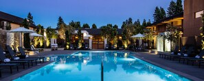 A swimming pool with lounge chairs and umbrellas, surrounded by buildings and trees. - Napa Valley Marriott Hotel & Spa (Napa)