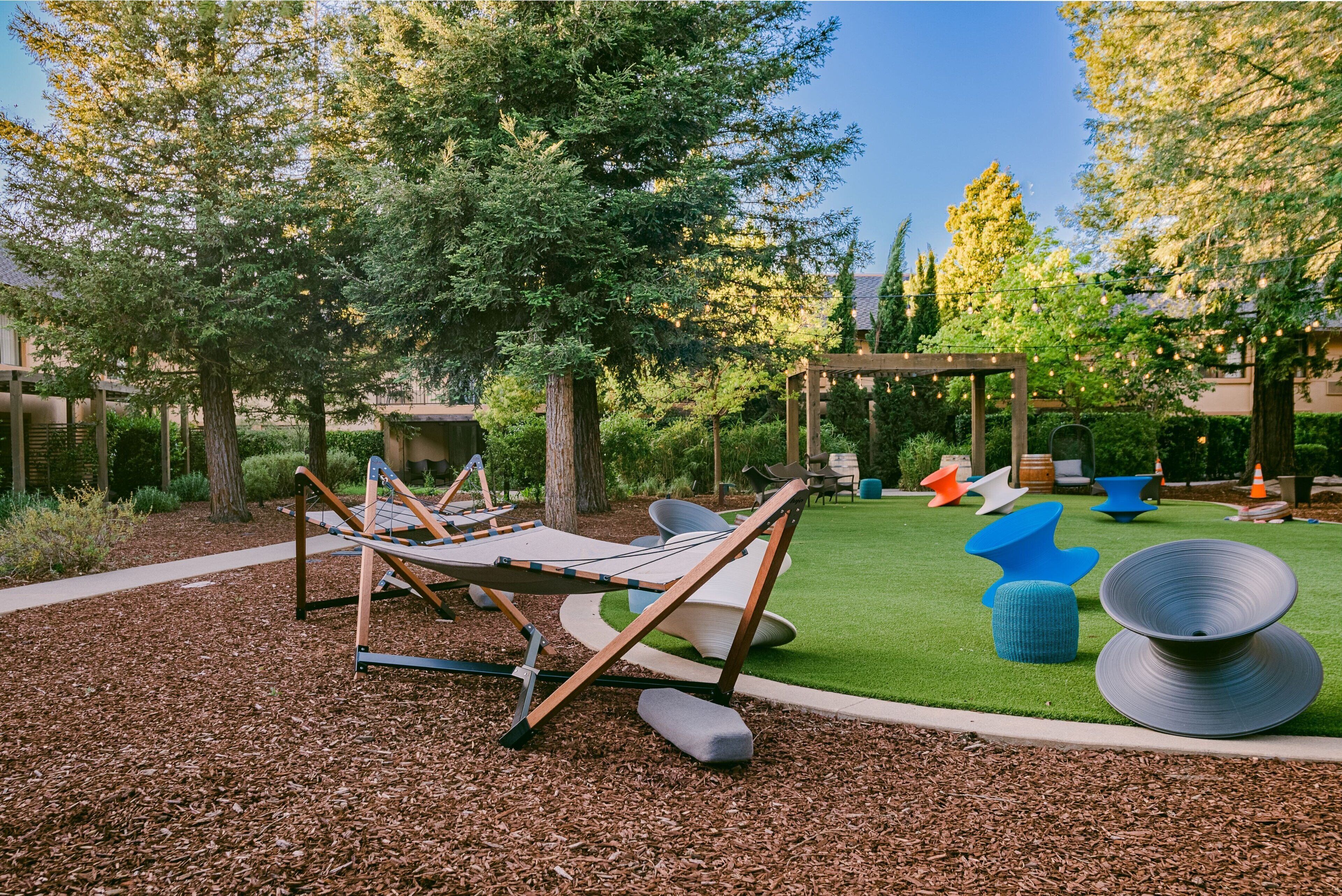 A playground with swings and modern seating.