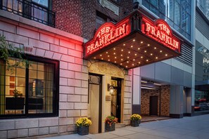 A theater marquee with the name 'The Franklin' and a brick facade with a large window. - voco The Franklin New York by IHG (New York)