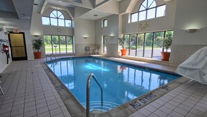 An indoor swimming pool with clear signage, a tiled floor, and large windows offering views of the outdoors. - Comfort Inn Near Greenfield Village (Dearborn)
