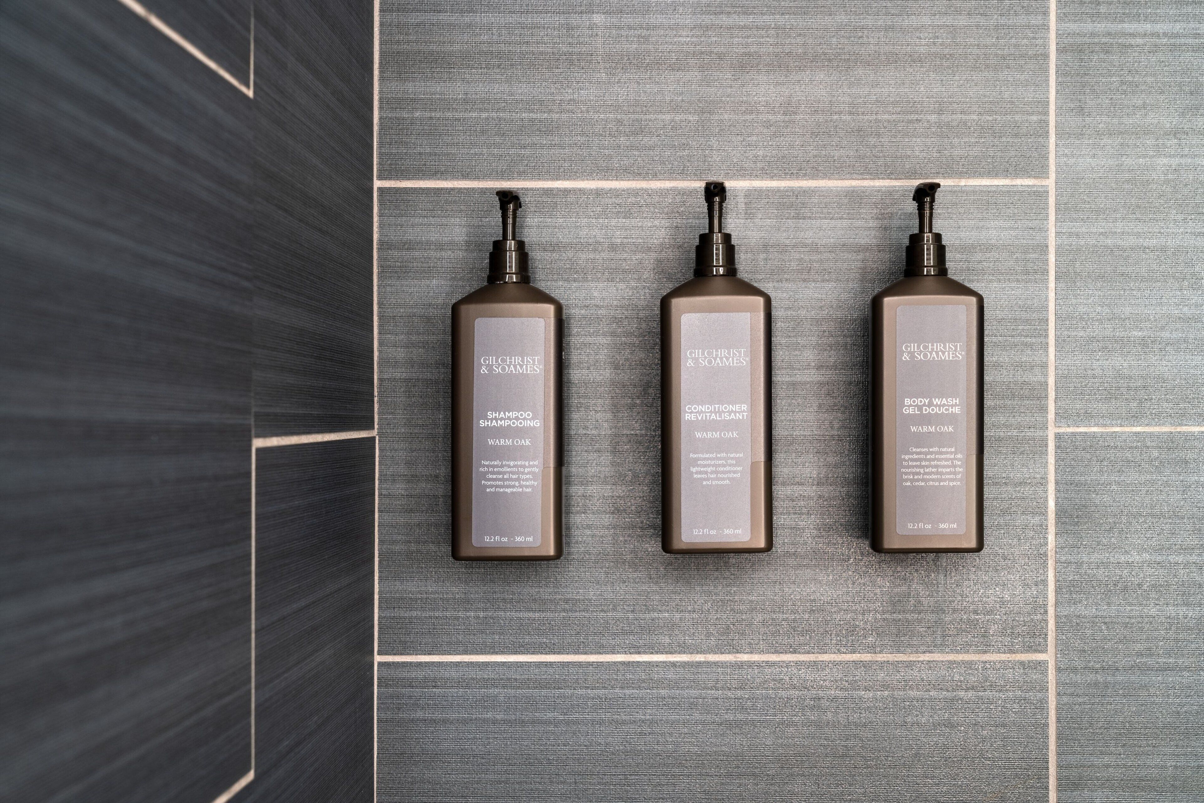 Three Gilchrist & Soames products on a textured grey surface.