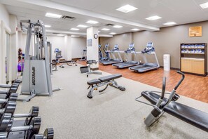 A gym with treadmills, weight machines, and dumbbells. - Embassy Suites by Hilton Parsippany (Parsippany)