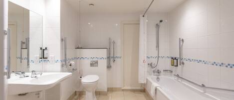 A modern bathroom with a sink, toilet, shower, and bathtub.