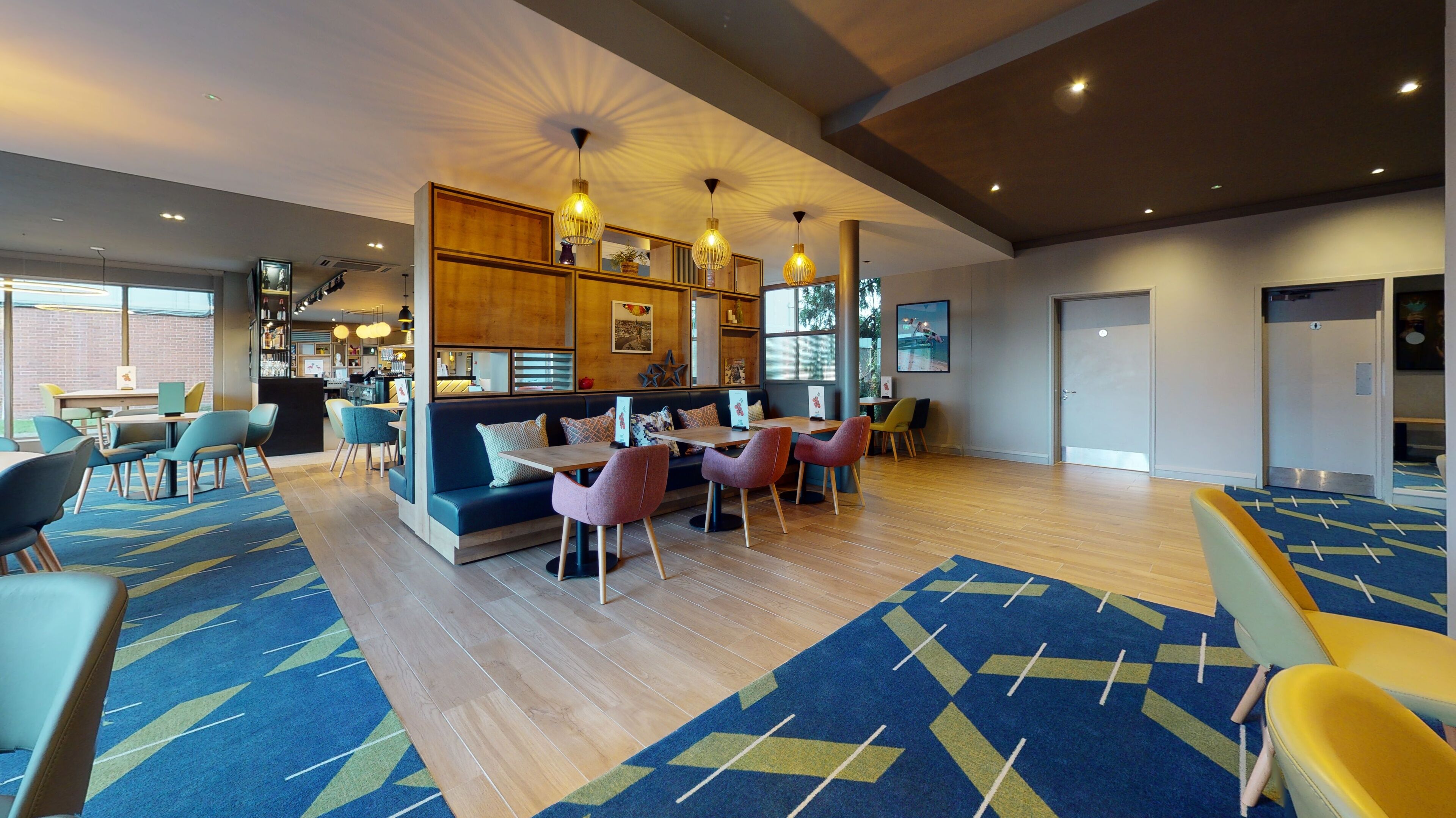 A modern lounge area with a sofa, chairs, and a dining table.
