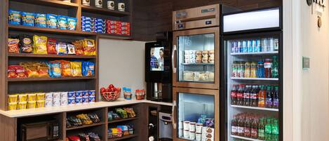 A snack and beverage vending area with various snack options and a refrigerated section.