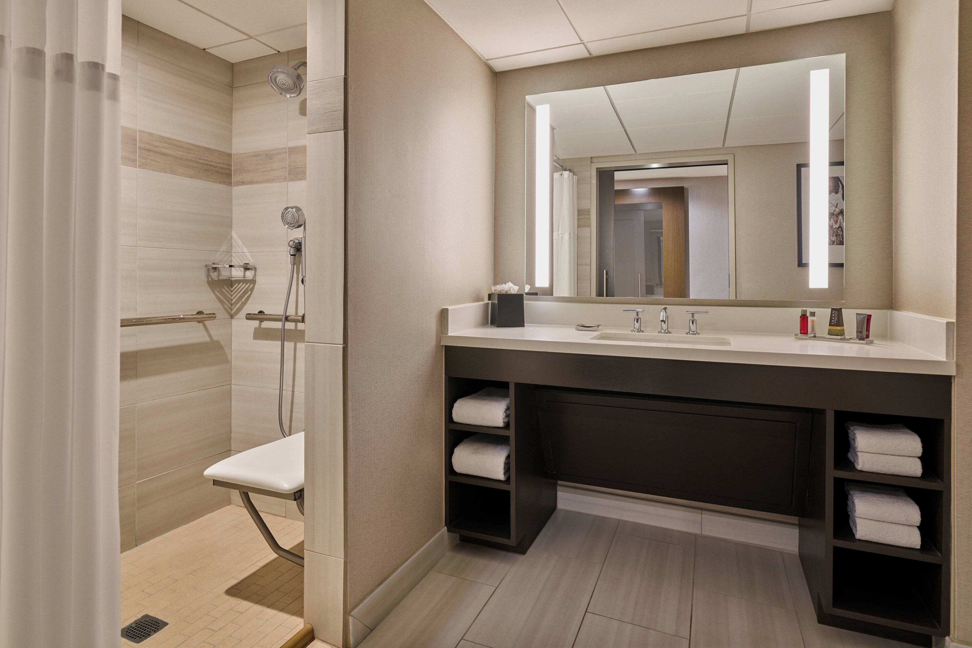 combined shower/bathtub, designer toiletries, hair dryer, towels