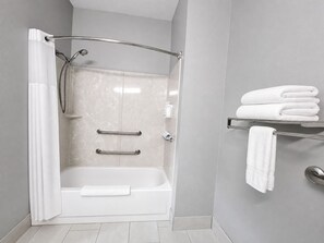 A modern bathroom with a walk-in shower, a bathtub, and a towel rack. - AmericInn by Wyndham Minot (Minot)