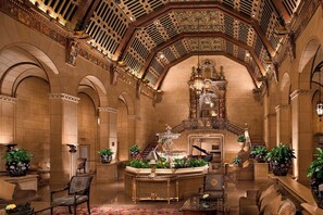 An ornate lobby with a grand staircase, a piano, and classical architecture. - The Biltmore Los Angeles (Los Angeles)