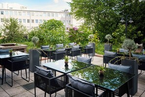 Relax in a serene outdoor setting surrounded by lush greenery and urban views.
