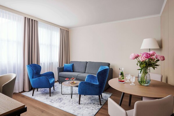 Relax in this inviting space with a comfortable sofa, armchair, and coffee table.