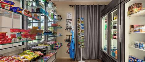 A store with shelves stocked with snacks, beverages, and packaged goods.
