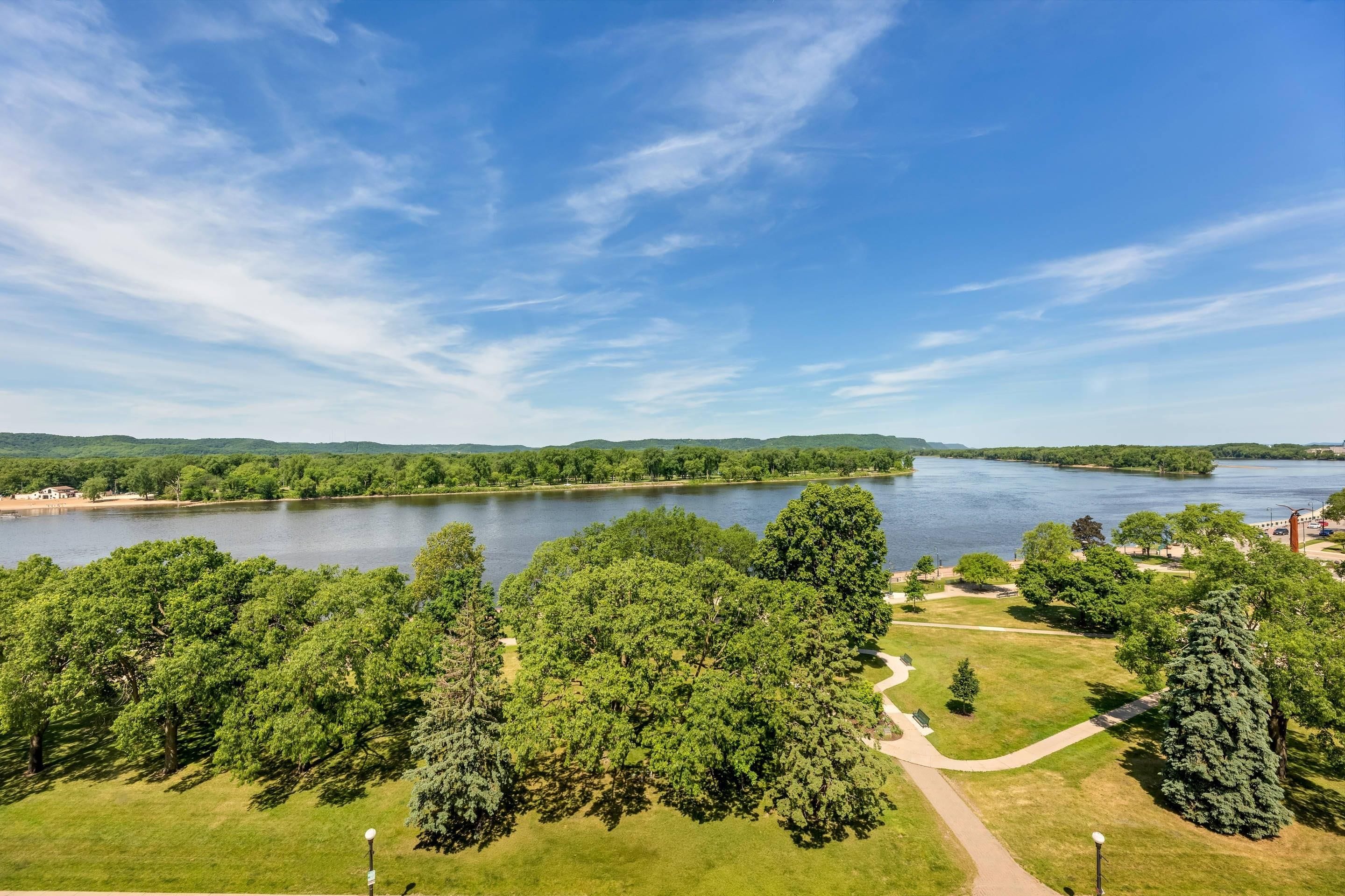 A park with a lake, pathways, and trees.
