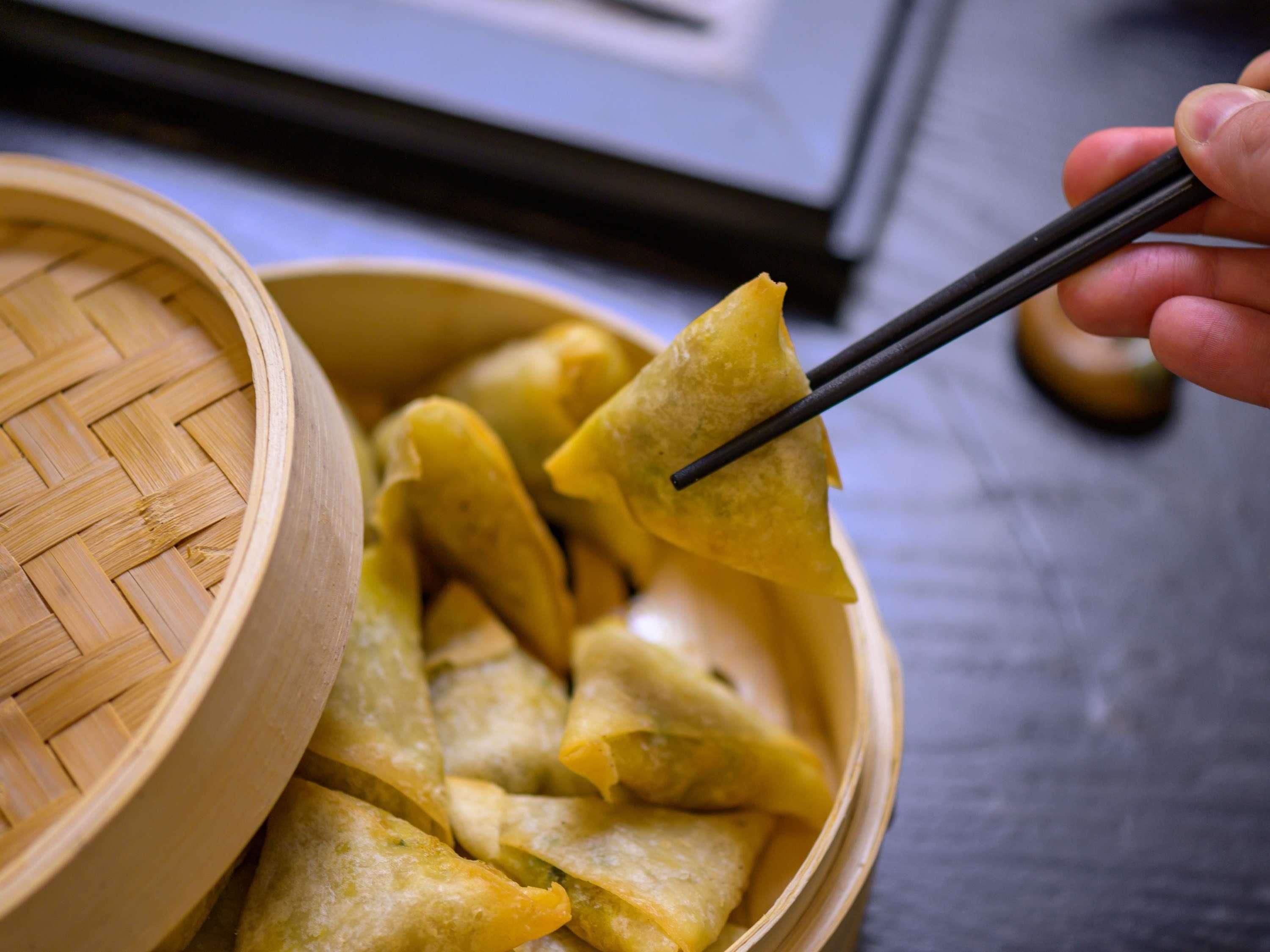 A bowl of food with chopsticks.