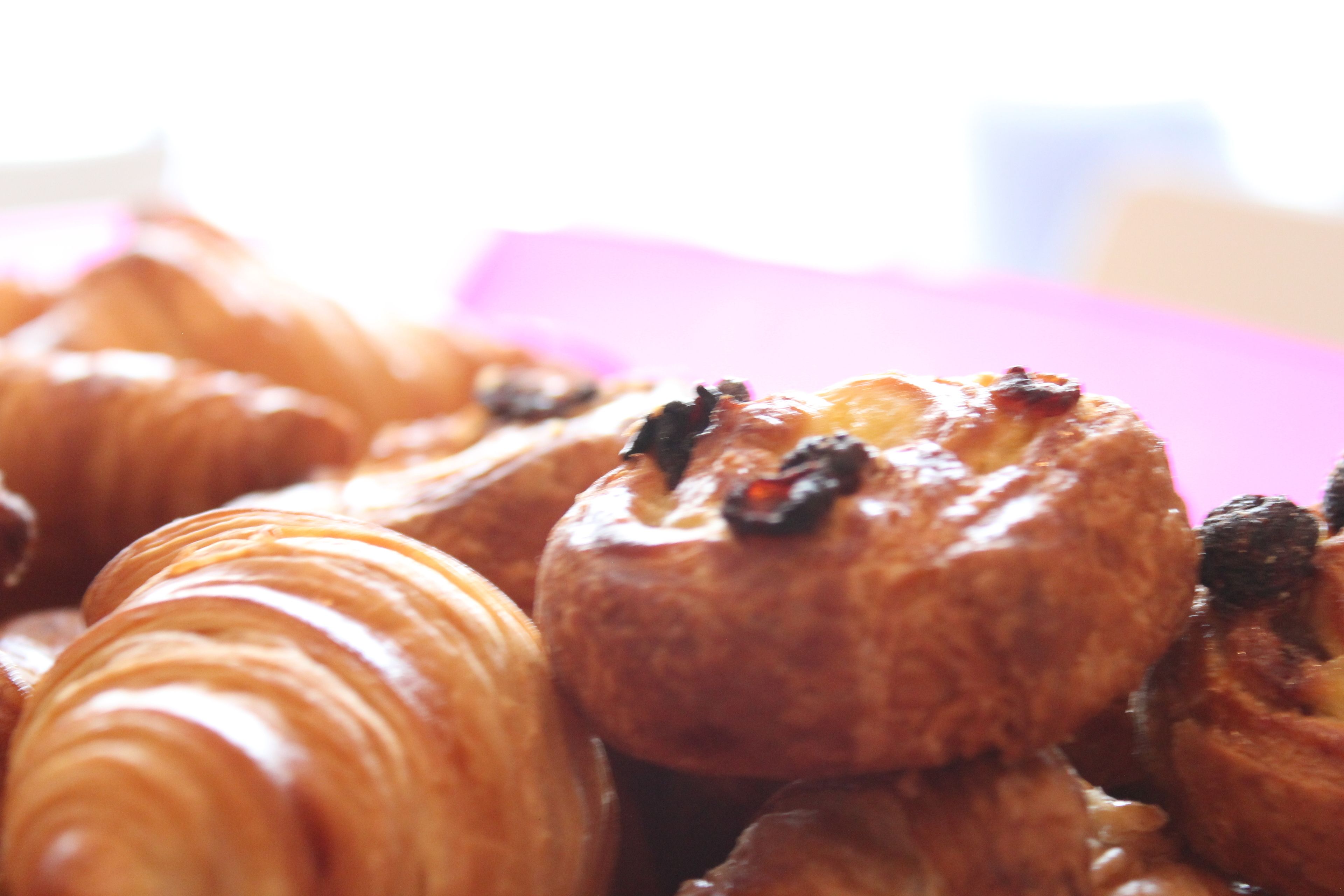 A close-up of pastries with visible raisins on top.