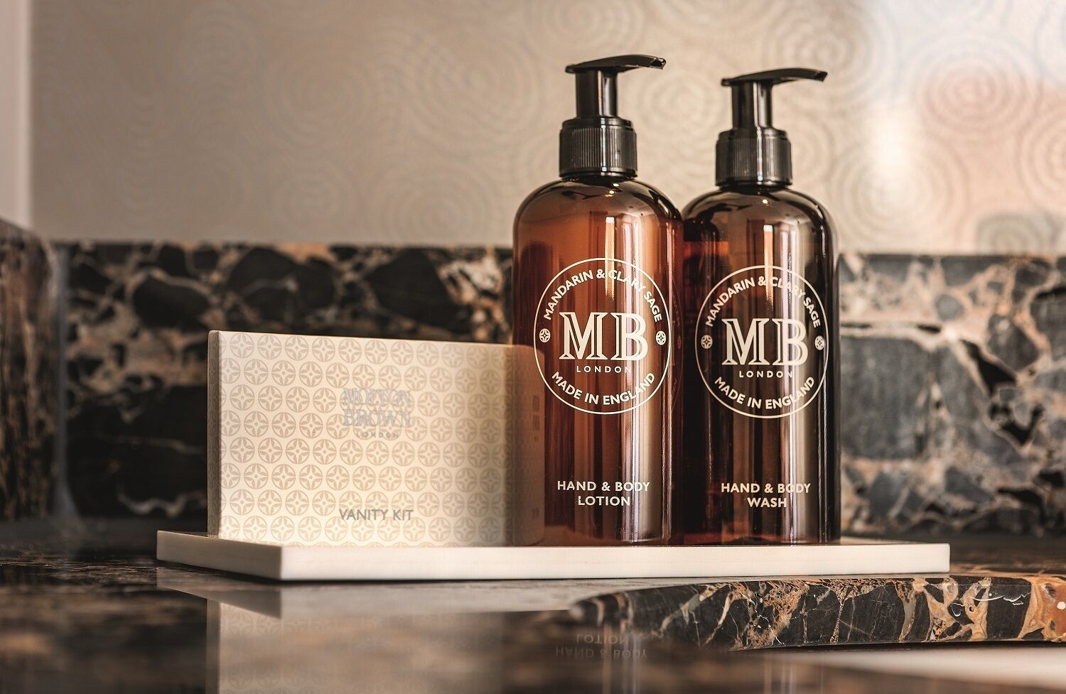 designer toiletries, hair dryer, bathrobes, slippers