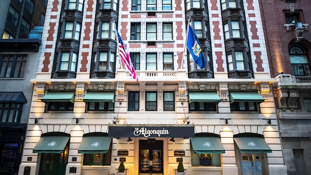 A hotel with a classic facade, featuring a prominent entrance with a black awning and a sign reading "The Algonquin."