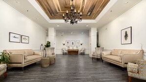 A spacious living area with two sofas, a wooden ceiling, and a chandelier. - Sea Palms Resort St Simons Island (St. Simons Island)