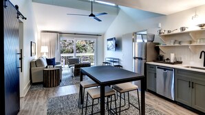 A modern kitchen with a dining area, a ceiling fan, and a view to the outside. - Sea Palms Resort St Simons Island (St. Simons Island)