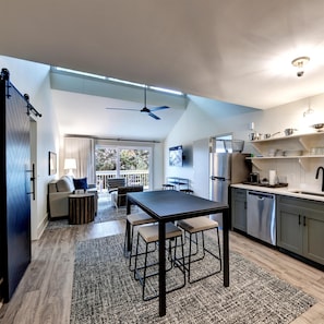A modern kitchen with a dining area, a ceiling fan, and a view to the outside. - Sea Palms Resort St Simons Island (St. Simons Island)
