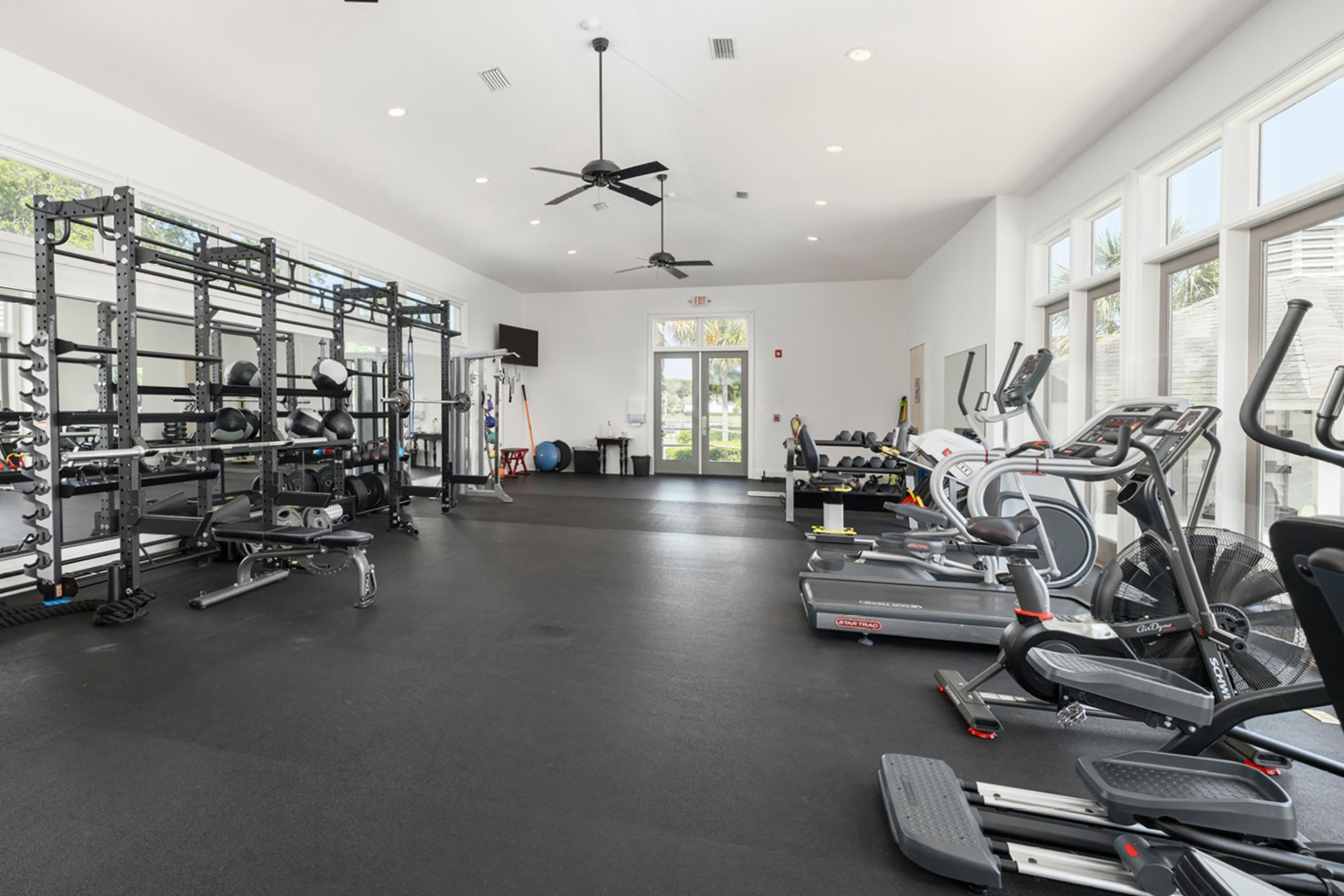 A gym with various exercise equipment, including treadmills and weight machines.