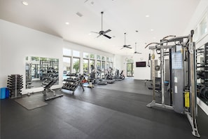 A gym with ceiling fans, exercise equipment, and large windows. - Sea Palms Resort St Simons Island (St. Simons Island)