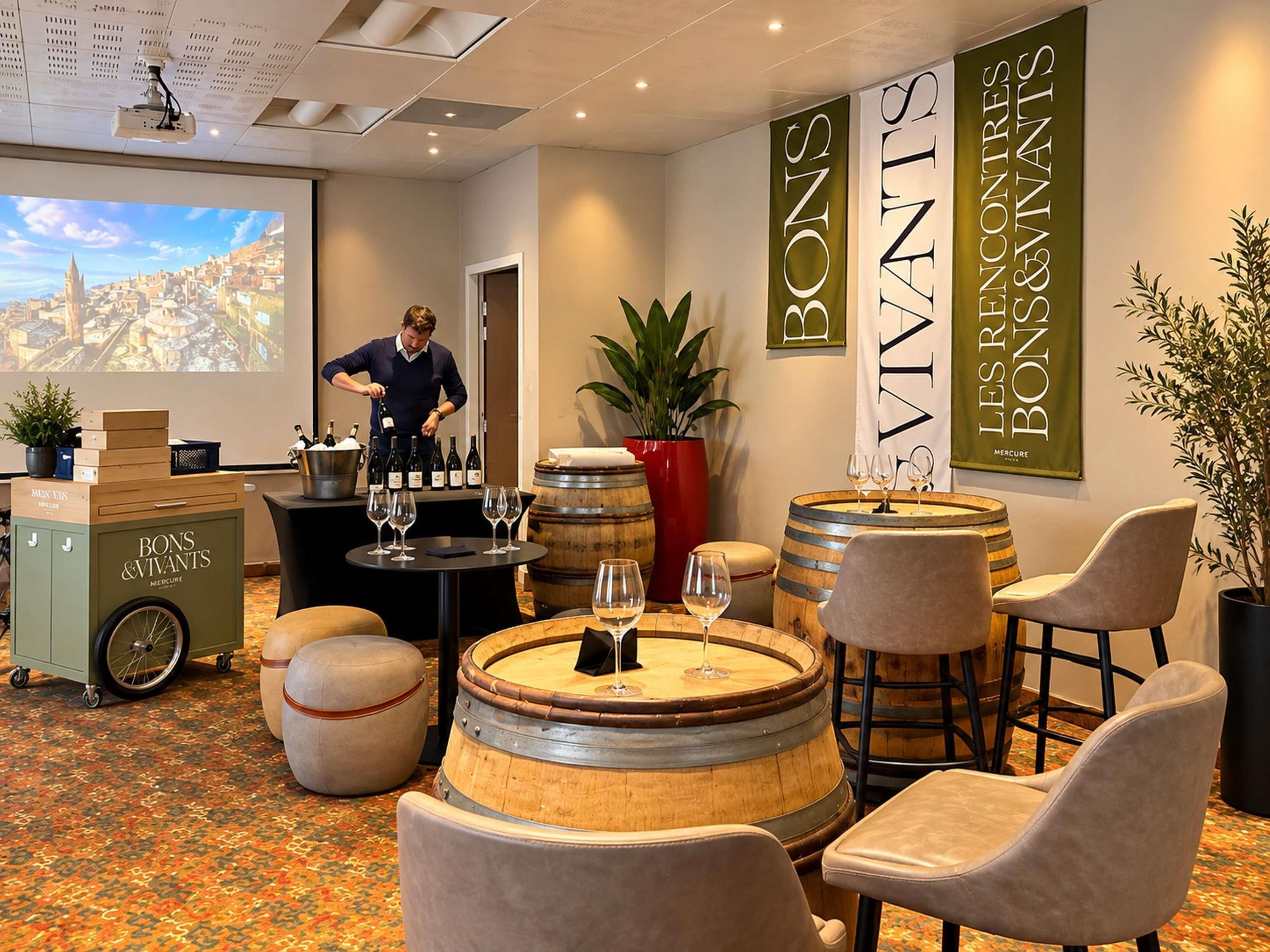 A wine tasting room with barrels, wine glasses, and a bartender.