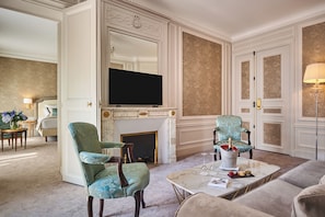 Relax in style with plush armchairs and a large flat-screen TV above the fireplace.