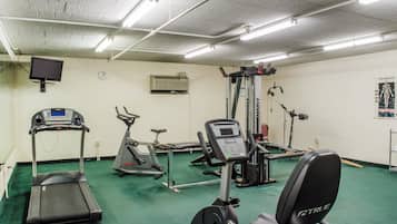 A gym with treadmills, an elliptical, and weight machines.