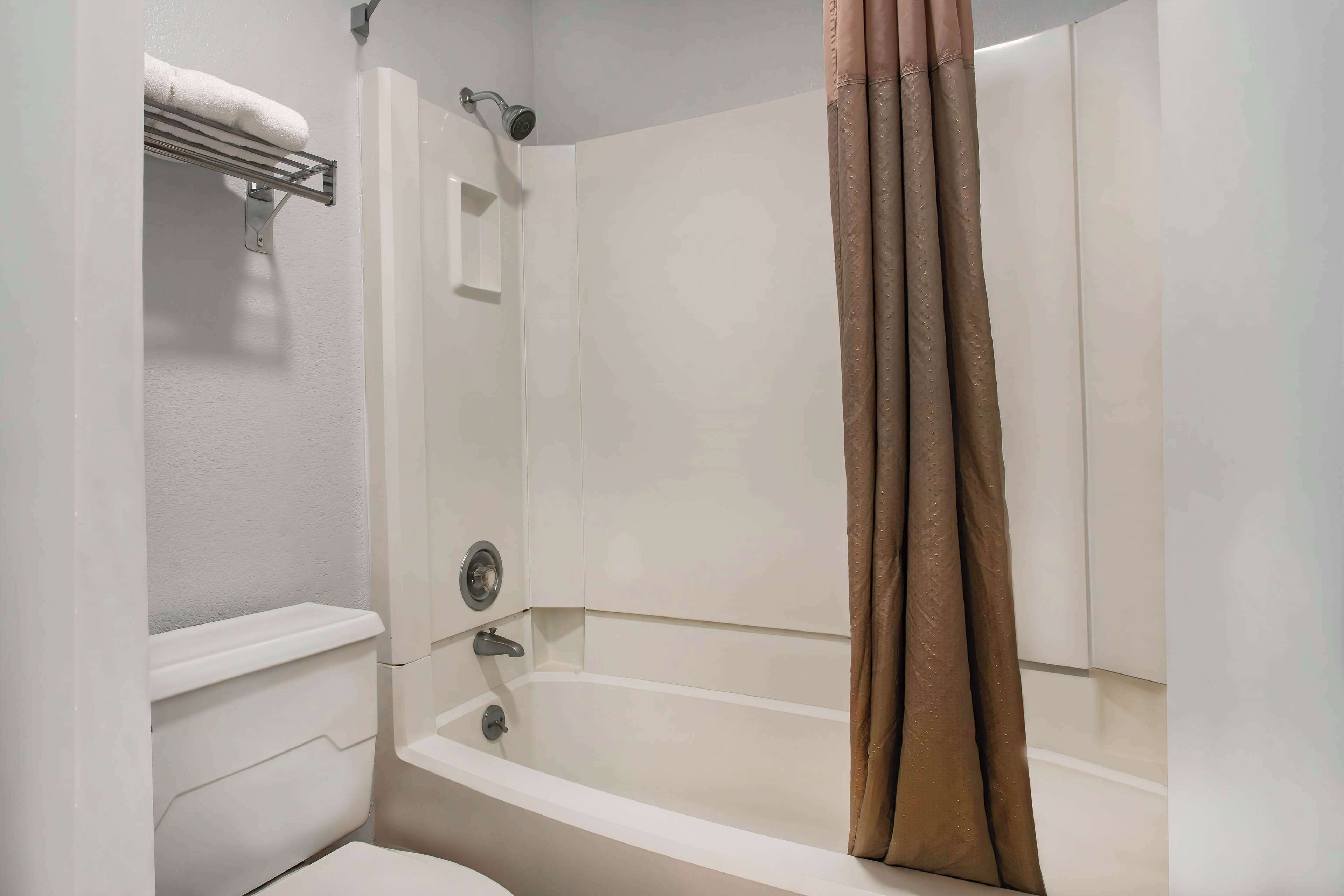 A bathroom with a bathtub, a shower, and a toilet.