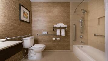 Un baño moderno con inodoro, lavamanos y bañera.