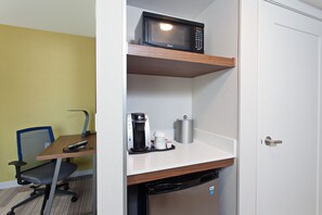 A compact hotel room with a kitchenette, a microwave, a coffee maker, and a compact dishwasher. - Holiday Inn Express & Suites Pasadena - Los Angeles by IHG (Pasadena)