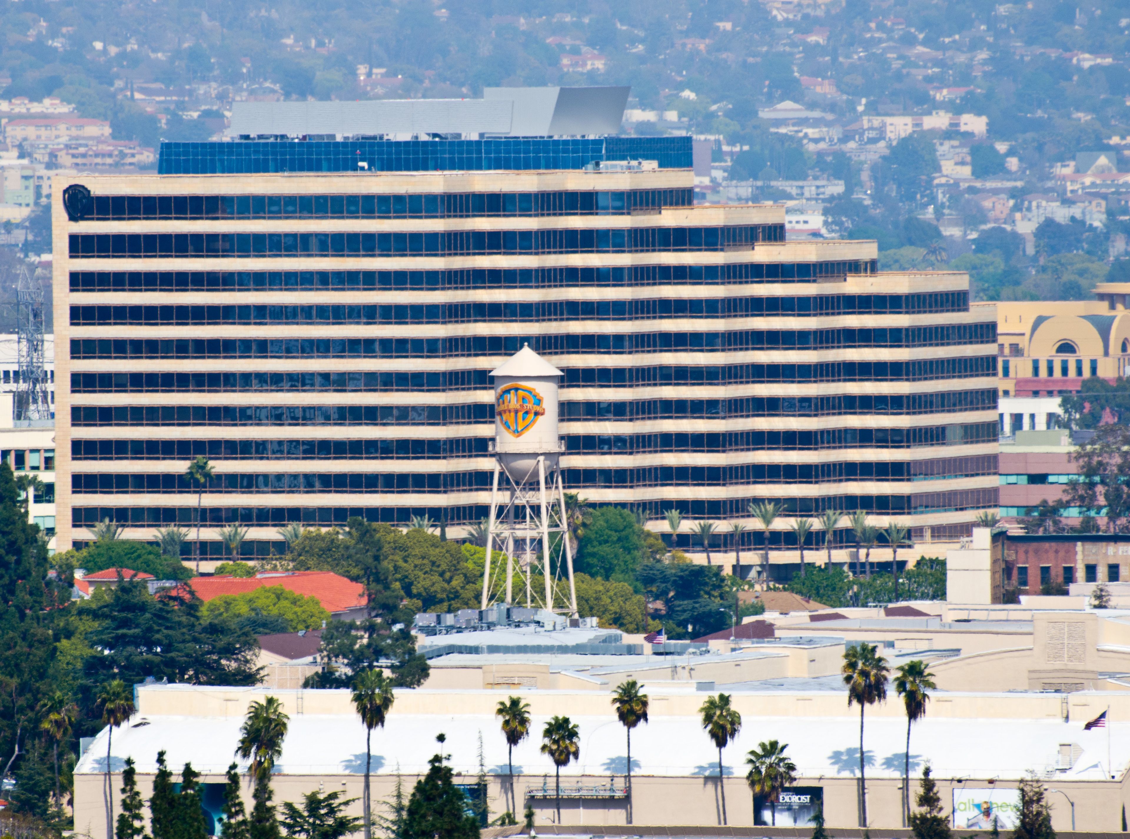 A large multi-story building with a prominent water tower in front.