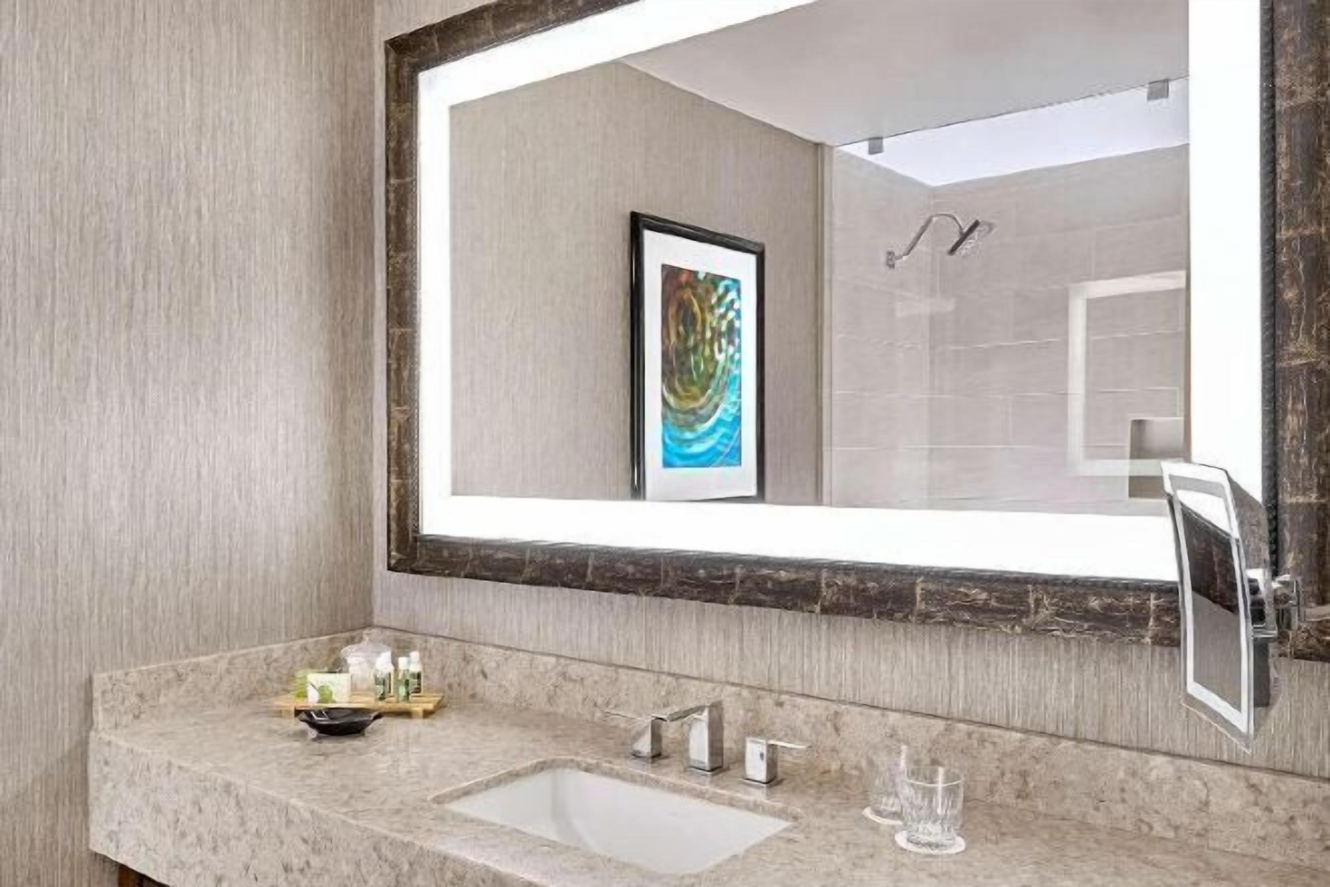 Bañera con ducha, artículos de tocador de diseñador, secador de pelo